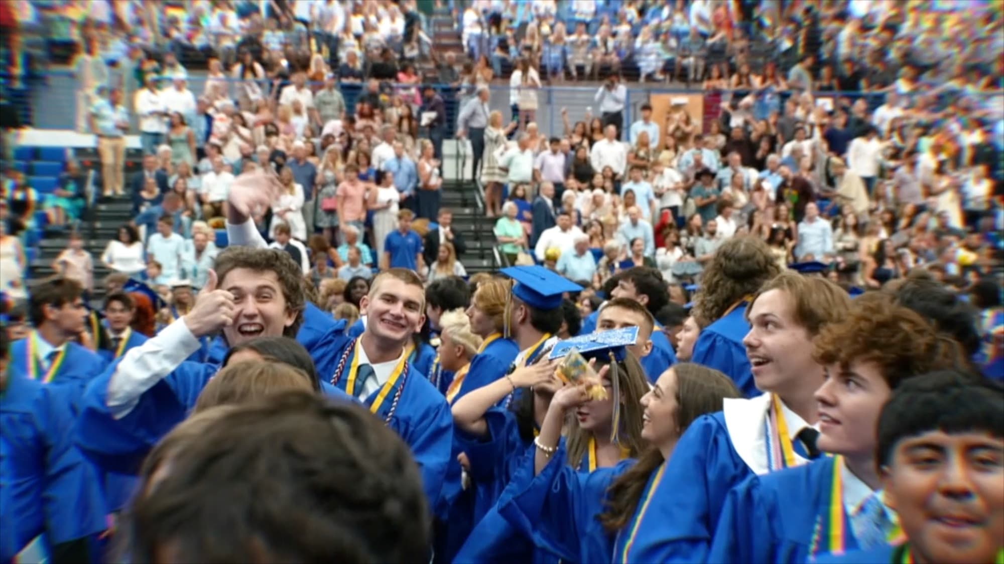 Graduates cheering during a Martin County high school graduation ceremony