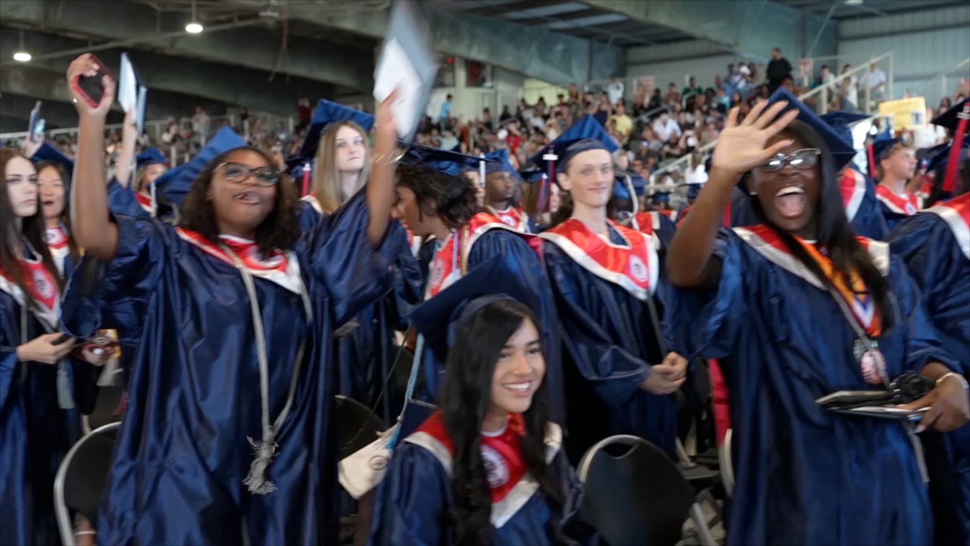 Graduates celebrating and taking photos after receiving their diplomas